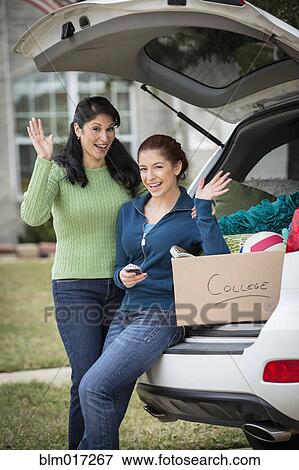 Hispanic mother helping daughter pack for college View Large Photo Image Stock Photo - Hispanic mother helping daughter pack for college. Fotosearch