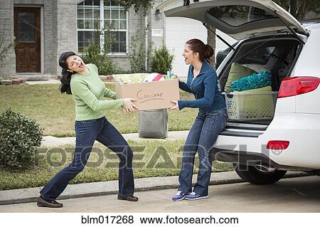 Hispanic mother helping daughter pack for college View Large Photo Image Stock Photo - Hispanic mother helping daughter pack for college. Fotosearch