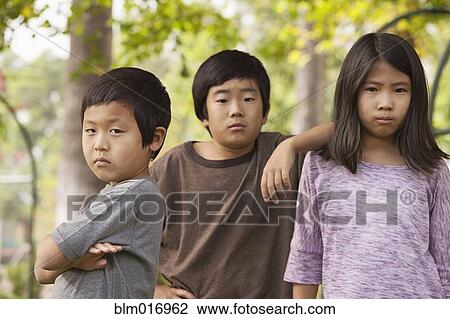 Stock Image - Korean children standing outdoors. Fotosearch