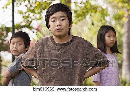 Stock Image - Korean children standing outdoors. Fotosearch