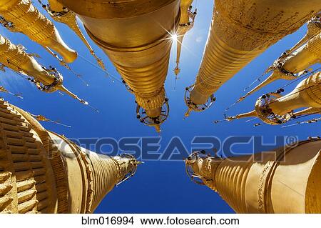 Picture - Low angle view of ornate spires and blue sky. Fotosearch