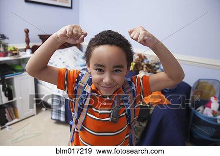 Mixed race boy wearing backpack in bedroom View Large Photo Image Stock Photo - Mixed race boy wearing backpack in bedroom. Fotosearch