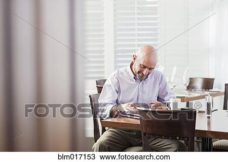 Mixed race businessman working in cafe View Large Photo Image Stock Image - Mixed race businessman working in cafe. Fotosearch