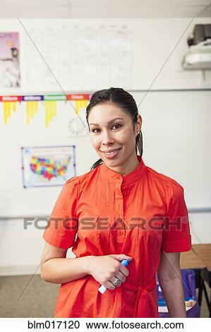 Mixed race teacher smiling in classroom View Large Photo Image Stock Image - Mixed race teacher smiling in classroom. Fotosearch