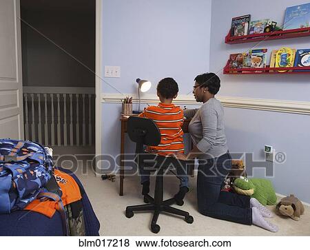 Mother helping son with homework View Large Photo Image Stock Photo - Mother helping son with homework. Fotosearch