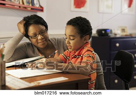 Mother helping son with homework View Large Photo Image Stock Photograph - Mother helping son with homework. Fotosearch