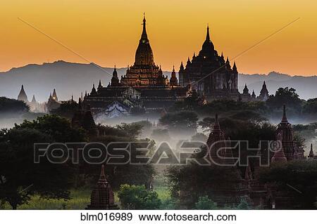 Stock Photo - Ornate buildings overlooking treetops. Fotosearch