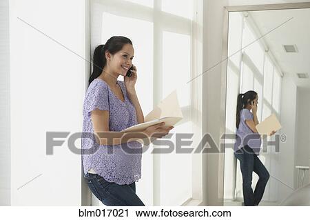 Pregnant Hispanic woman talking on cell phone View Large Photo Image Stock Image - Pregnant Hispanic woman talking on cell phone. Fotosearch