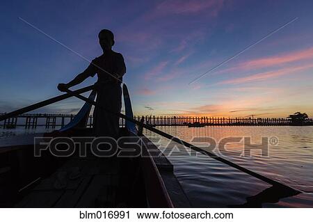Silhouette of man rowing canoe at sunset View Large Photo Image Stock Image - Silhouette of man rowing canoe at sunset. Fotosearch
