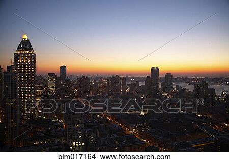 Sunset and illuminated cityscape, New York, New York, United States View Large Photo Image Picture - Sunset and illuminated cityscape, New York, New York, United States. Fotosearch