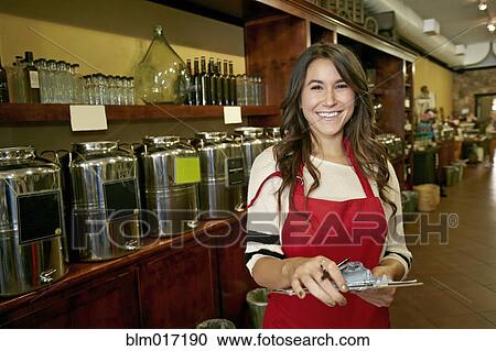 Woman working in grocery store View Large Photo Image Stock Image - Woman working in grocery store. Fotosearch