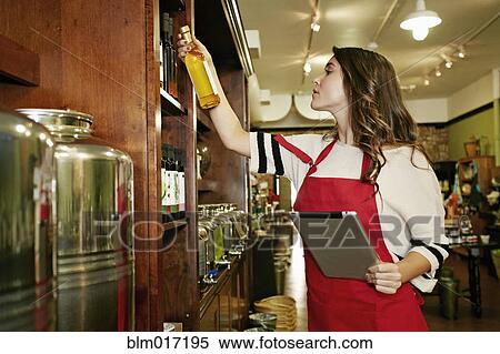 Woman working in grocery store View Large Photo Image Stock Photography - Woman working in grocery store. Fotosearch