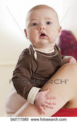 Stock Photography - Baby looking over mother's shoulder. Fotosearch