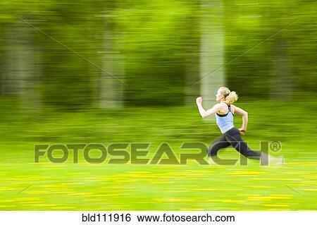 Blurred view of Caucasian woman running in tall grass View Large Photo Image Stock Photograph - Blurred view of Caucasian woman running in tall grass. Fotosearch