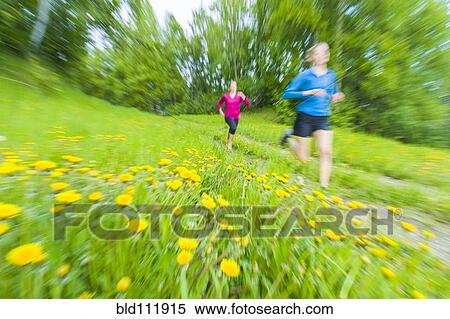 Stock Photography - Blurred view of Caucasian women running on path. Fotosearch