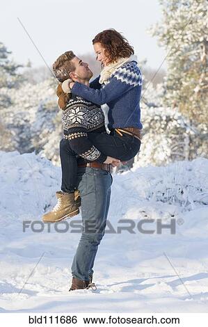 Caucasian couple hugging in snow View Large Photo Image Stock Photograph - Caucasian couple hugging in snow. Fotosearch
