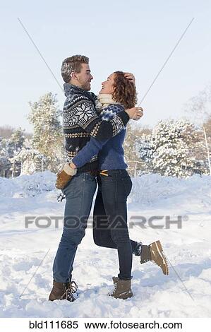 Caucasian couple hugging in snow View Large Photo Image Stock Photography - Caucasian couple hugging in snow. Fotosearch