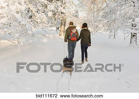 Caucasian couple pulling sled in snow View Large Photo Image Stock Image - Caucasian couple pulling sled in snow. Fotosearch