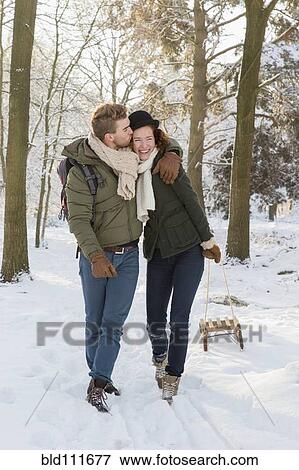 Caucasian couple pulling sled in snow View Large Photo Image Stock Photo - Caucasian couple pulling sled in snow. Fotosearch