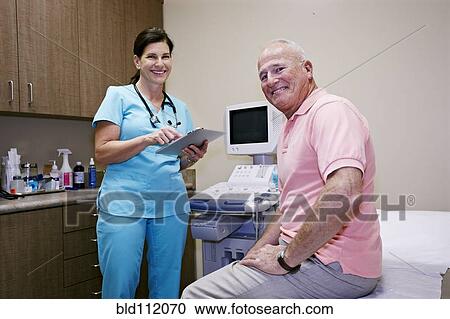Caucasian nurse and patient smiling in office View Large Photo Image Stock Image - Caucasian nurse and patient smiling in office. Fotosearch