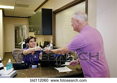 Caucasian nurse handing clipboard to patient View Large Photo Image Stock Image - Caucasian nurse handing clipboard to patient. Fotosearch