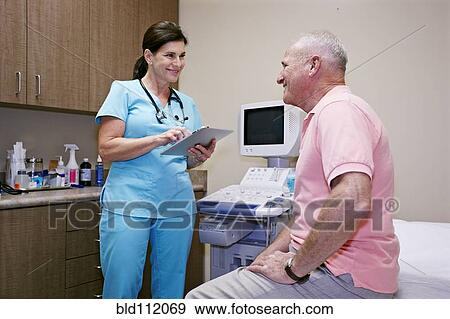 Stock Photo - Caucasian nurse talking to patient in office. Fotosearch