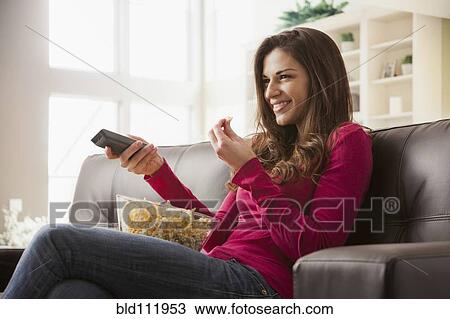 Caucasian watching television on sofa View Large Photo Image Stock Image - Caucasian watching television on sofa. Fotosearch