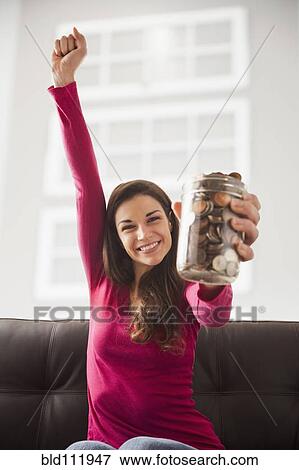 Caucasian woman cheering with jar of change View Large Photo Image Stock Photo - Caucasian woman cheering with jar of change. Fotosearch