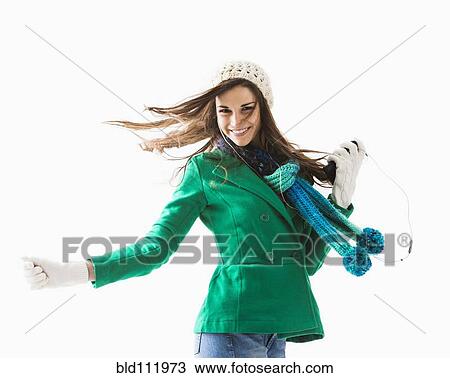 Stock Image - Caucasian woman listening to earphones. Fotosearch