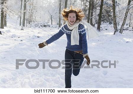 Stock Image - Caucasian woman playing in snow. Fotosearch