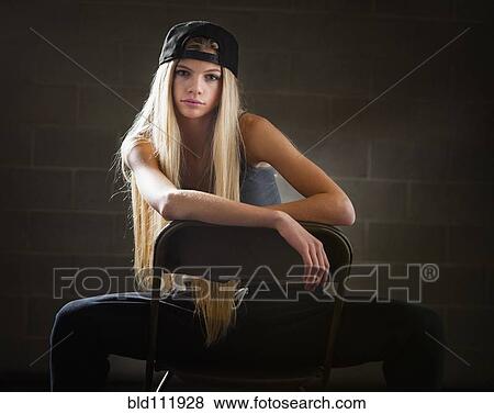 Stock Photo - Caucasian woman sitting in folding chair. Fotosearch