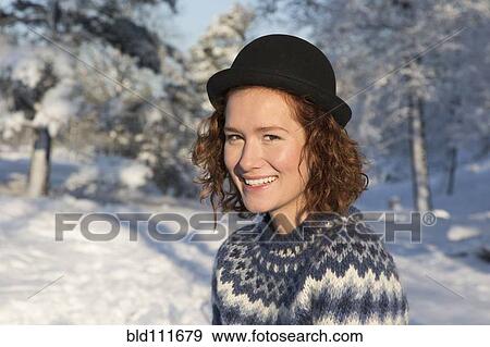 Stock Photo - Caucasian woman smiling in snow. Fotosearch