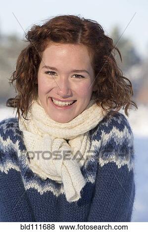Stock Photo - Caucasian woman smiling in snow. Fotosearch
