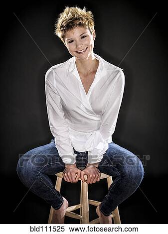 Stock Photography - Caucasian woman smiling on bench. Fotosearch