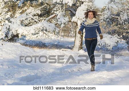 Caucasian woman walking in snow View Large Photo Image Stock Image - Caucasian woman walking in snow. Fotosearch