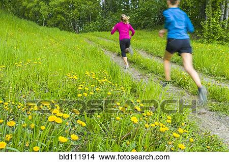 Picture - Caucasian women running on path. Fotosearch