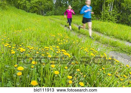 Stock Image - Caucasian women running on path. Fotosearch
