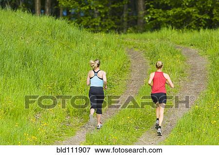 Caucasian women running on path View Large Photo Image Stock Photo - Caucasian women running on path. Fotosearch
