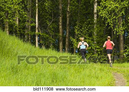 Caucasian women running on path View Large Photo Image Stock Photo - Caucasian women running on path. Fotosearch