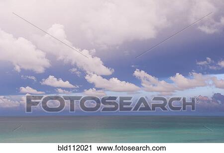 Stock Image - Clouds over tropical water. Fotosearch