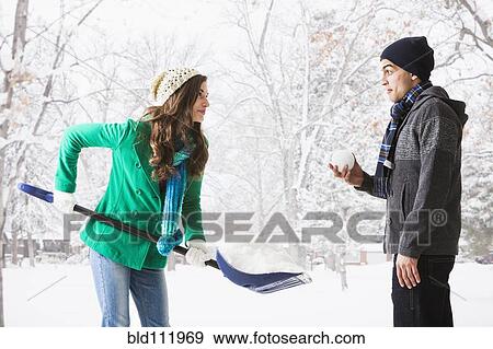 Stock Photo - Couple playing in snow. Fotosearch
