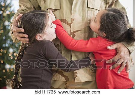 Daughters hugging soldier father View Large Photo Image Stock Photography - Daughters hugging soldier father. Fotosearch