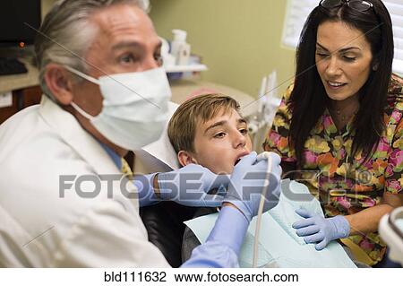 Dentist and nurse examining patient's mouth View Large Photo Image Stock Image - Dentist and nurse examining patient's mouth. Fotosearch