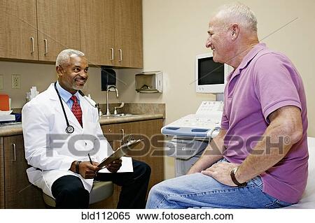 Doctor talking to patient in office View Large Photo Image Stock Photography - Doctor talking to patient in office. Fotosearch