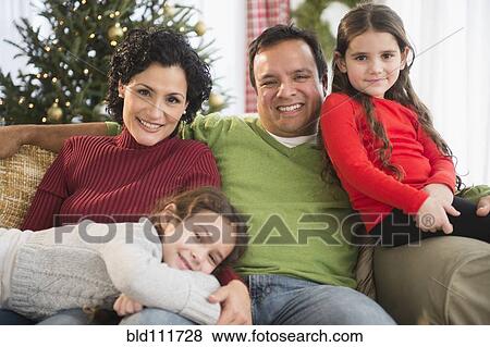 Family relaxing together on sofa View Large Photo Image Stock Photo - Family relaxing together on sofa. Fotosearch