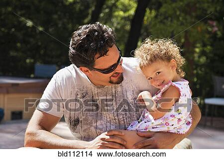 Picture - Father and daughter smiling outdoors. Fotosearch