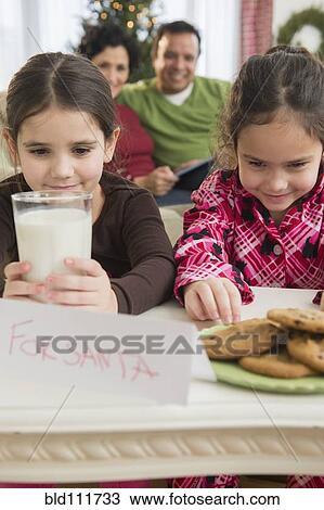 Girls leaving milk and cookies for Santa View Large Photo Image Stock Image - Girls leaving milk and cookies for Santa. Fotosearch