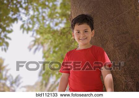 Stock Image - Hispanic boy smiling outdoors. Fotosearch