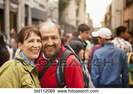 Stock Photo - Hispanic couple smiling on city street. Fotosearch