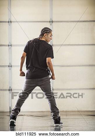 Stock Photography - Hispanic dancer practicing in studio. Fotosearch